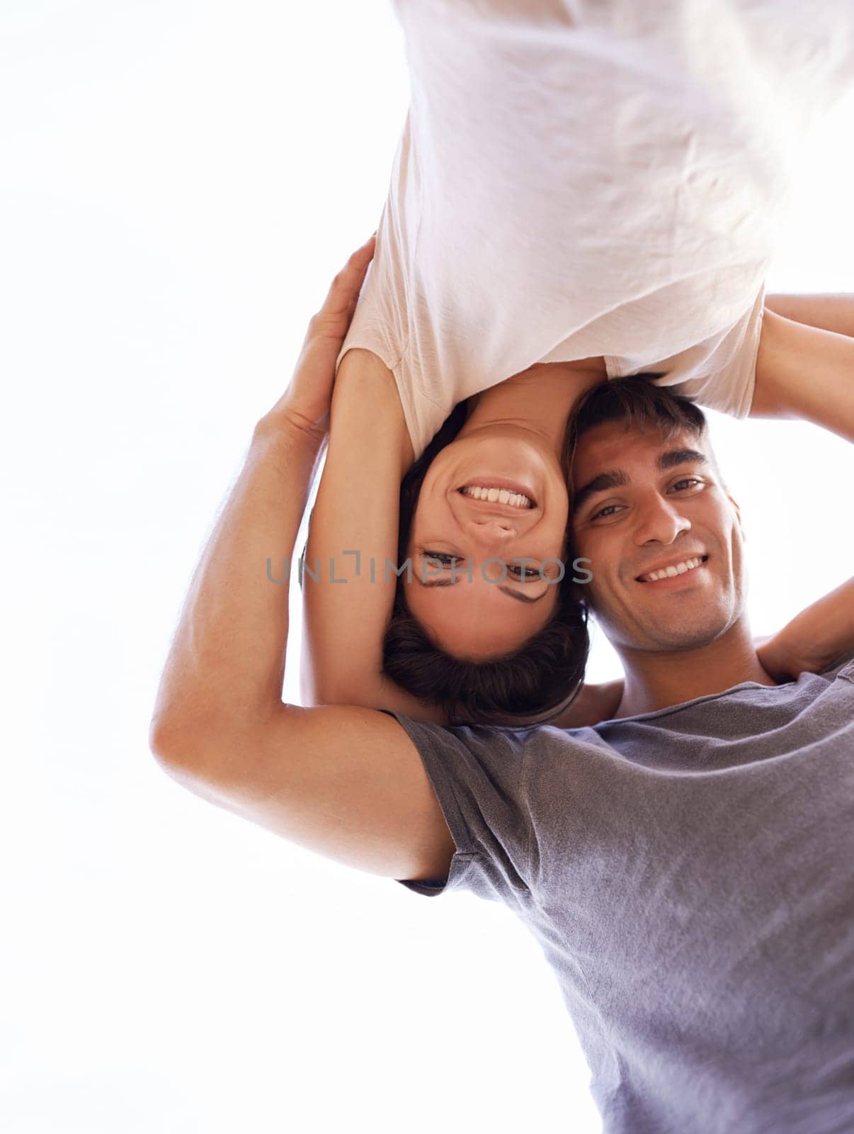 Couple, portrait and smile from low angle, outdoors and romance or bonding time. Happy man, loving woman and honeymoon or travel together in summer, nature and sky while affectionately embracing.