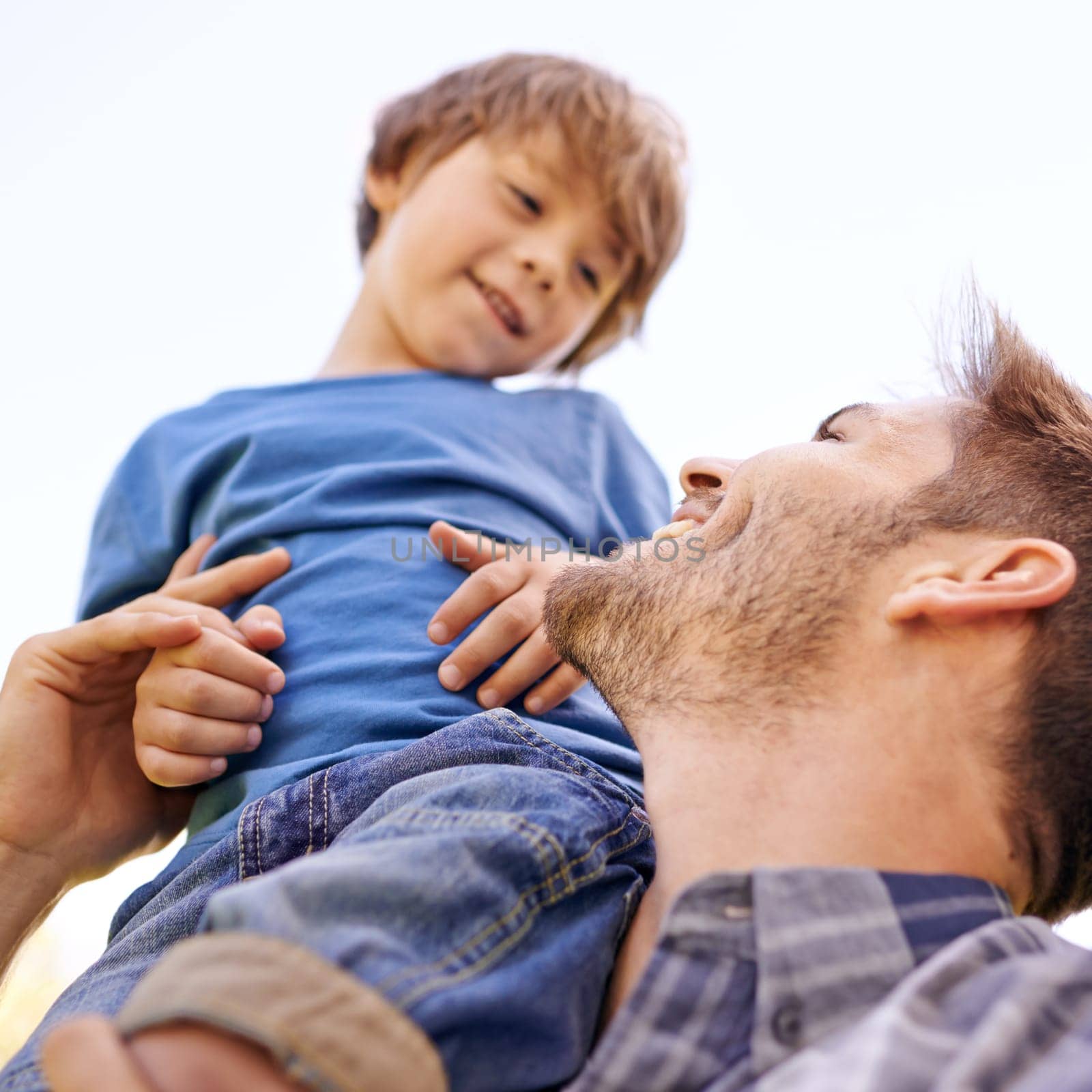 Family, smile and son on shoulder of father closeup outdoor for love, bonding or fun together. Face, happy or relax with man parent and boy child on sky from below for summer vacation or holiday by YuriArcurs
