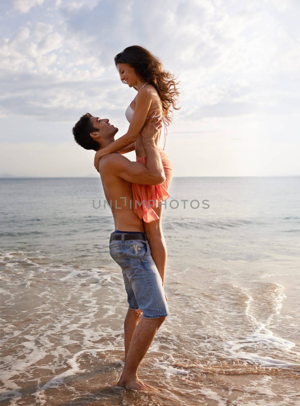 Embrace, waves and couple playing on beach for travel adventure, summer island holiday and relax. Ocean vacation, woman and man in nature on romantic date together with smile, love and sea in Bali. by YuriArcurs