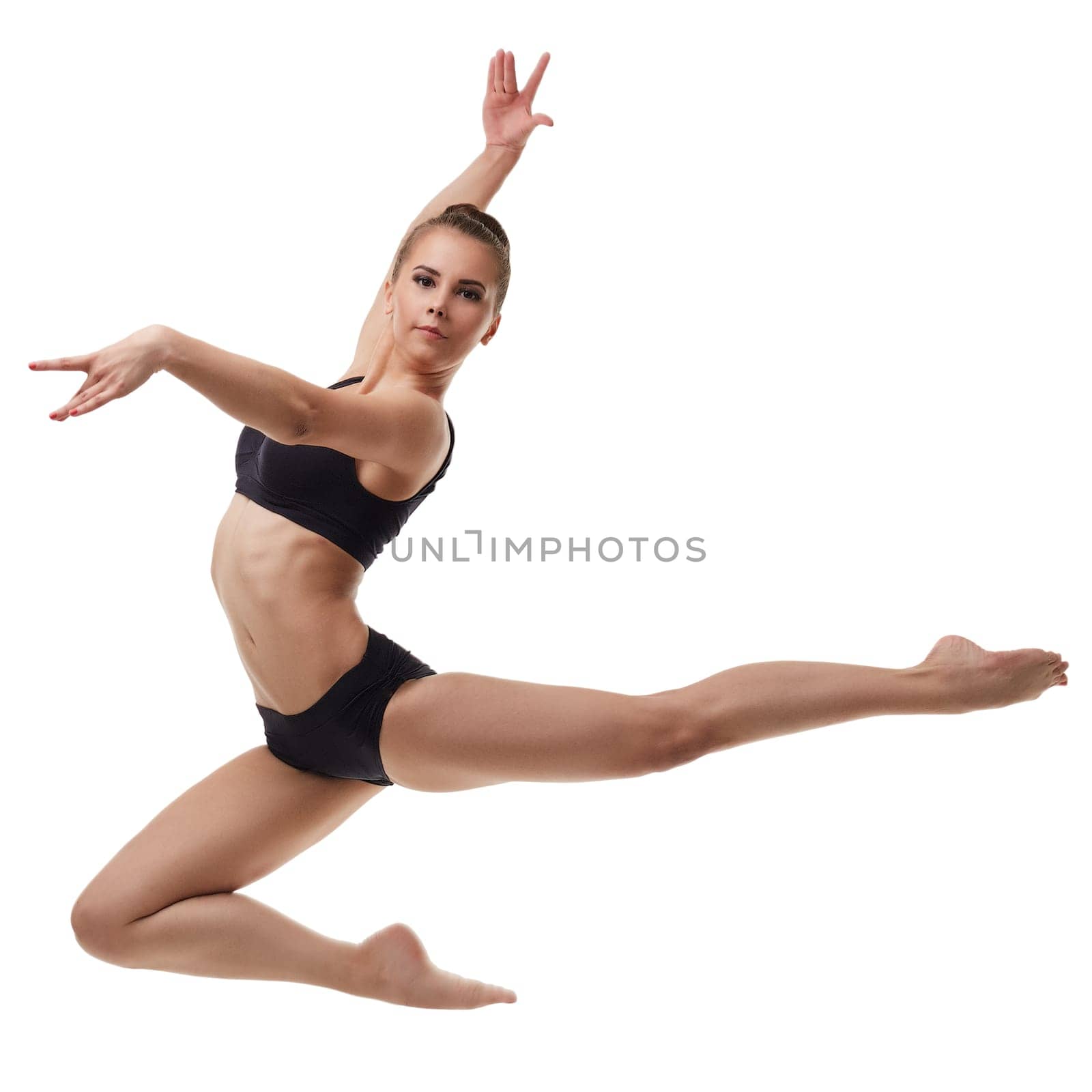 Beautiful female dancer posing in graceful jump by rivertime