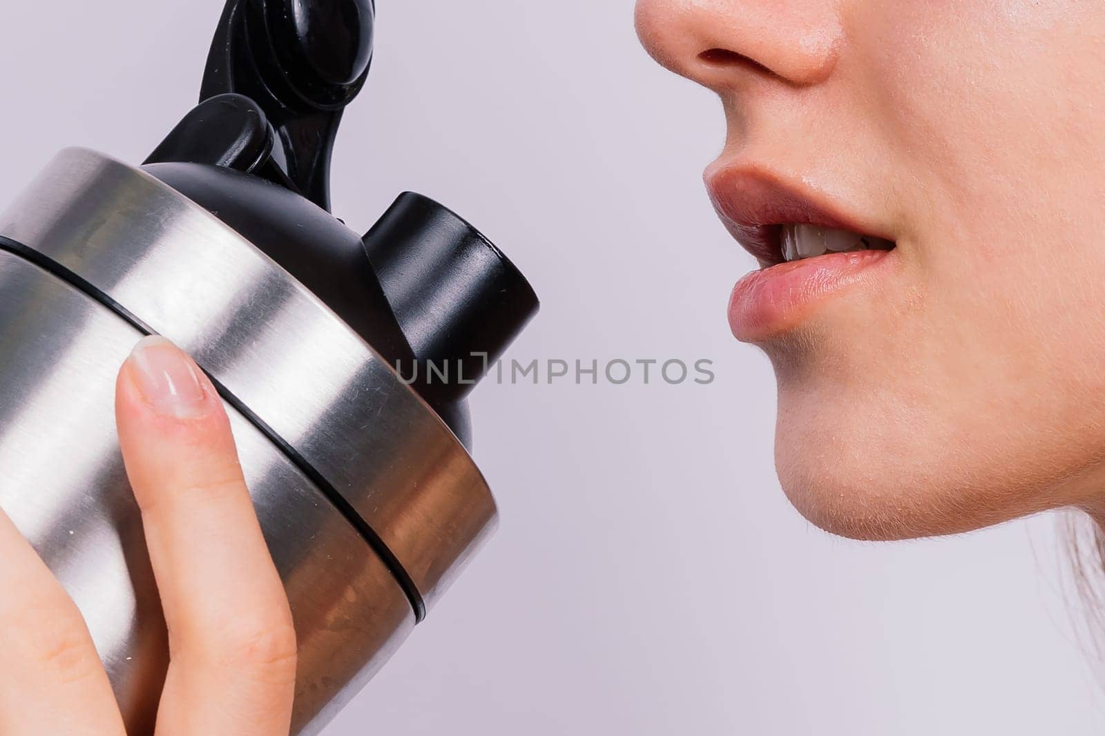 Image of beautiful strong happy cheerful young sports woman posing isolated indoors drinking water. by Zelenin