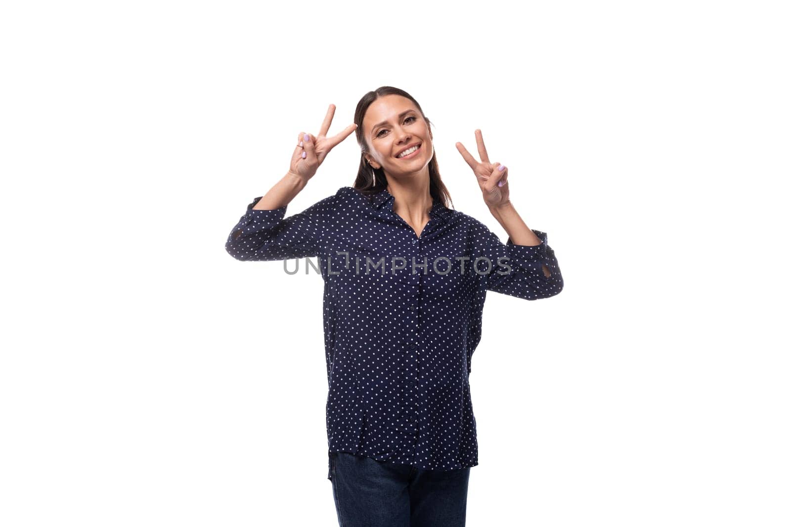 young European slender brunette woman in blue clothes smiles affably by TRMK