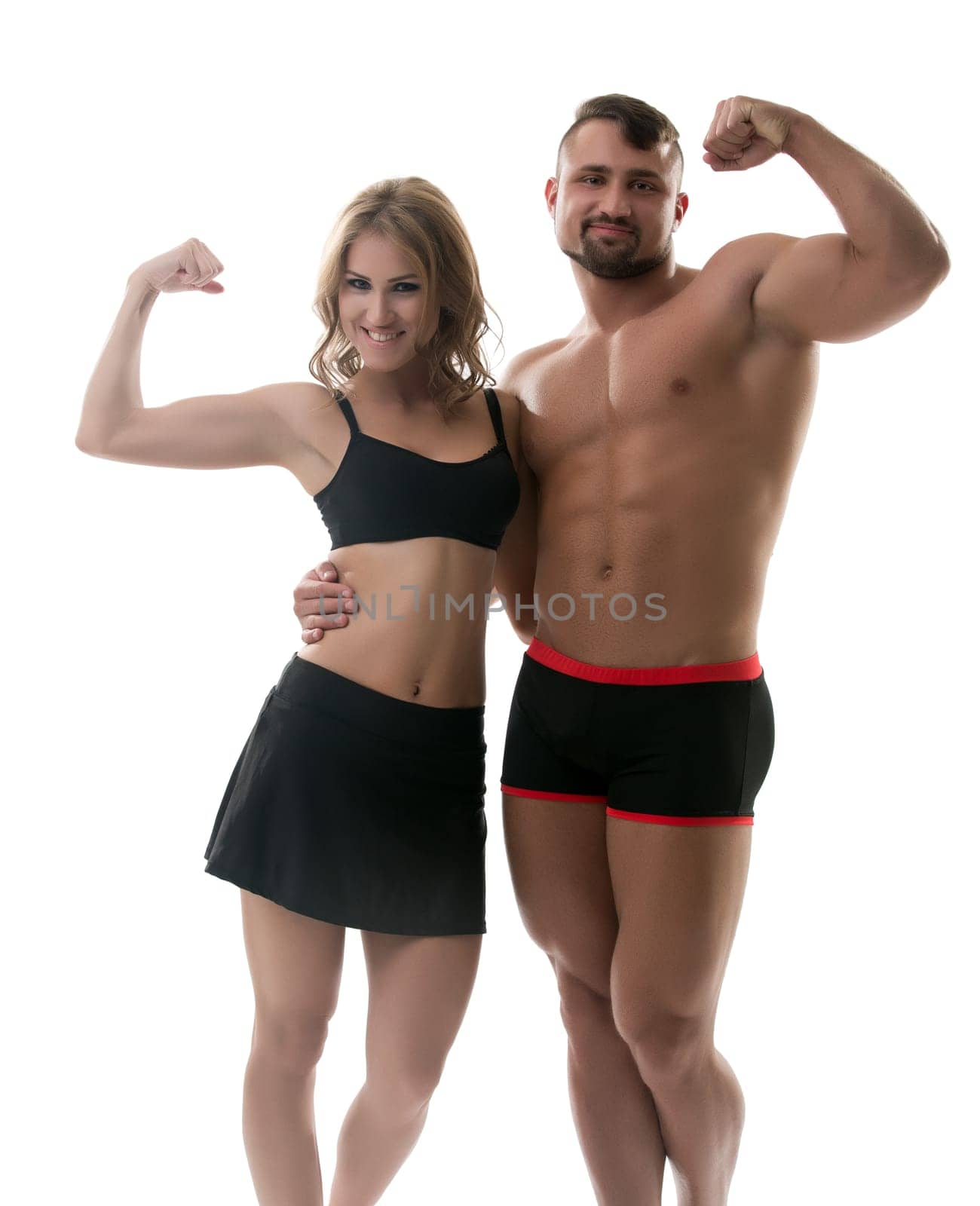 Cheerful handsome athletes showing biceps at camera