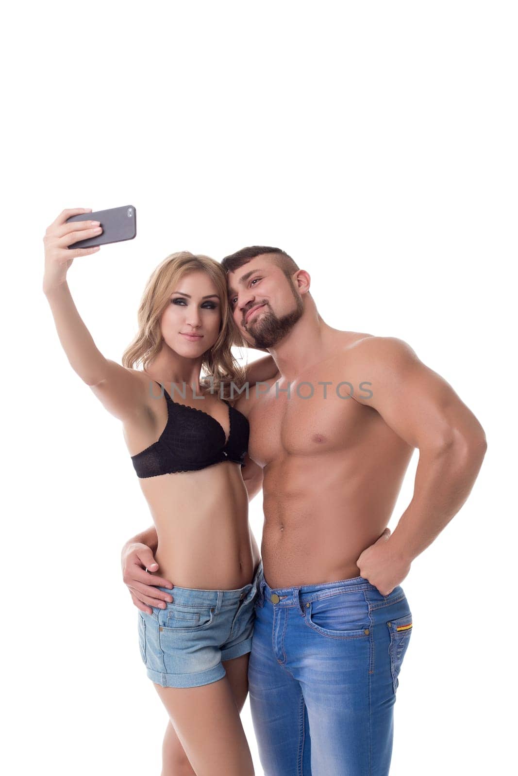 Cute couple athletes doing selfie on mobile phone. Isolated over white background