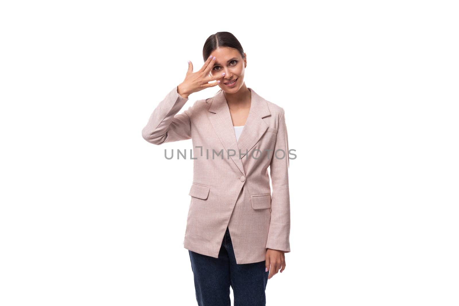 young cheerful smiling european brunette woman dressed in a stylish beige jacket by TRMK