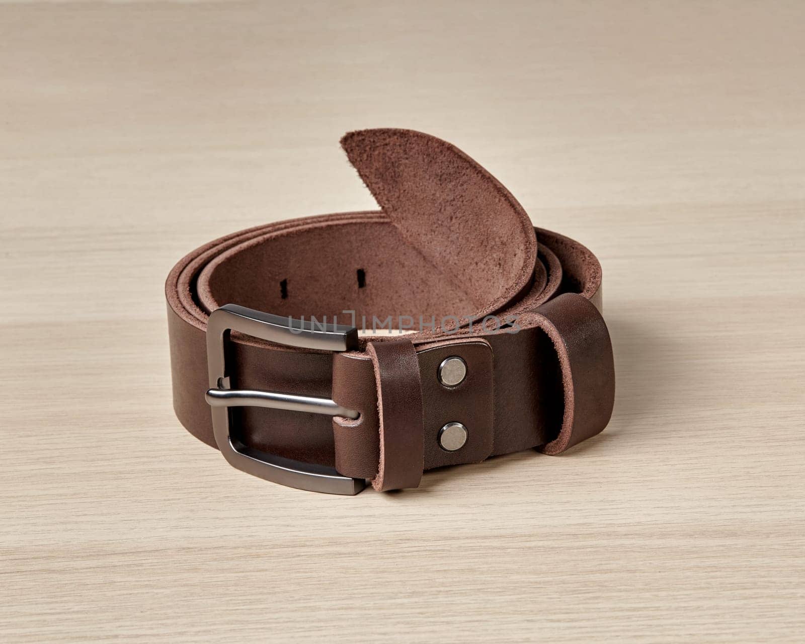 Folded dark brown leather belt with matte buckle and DAD embossing by nazarovsergey