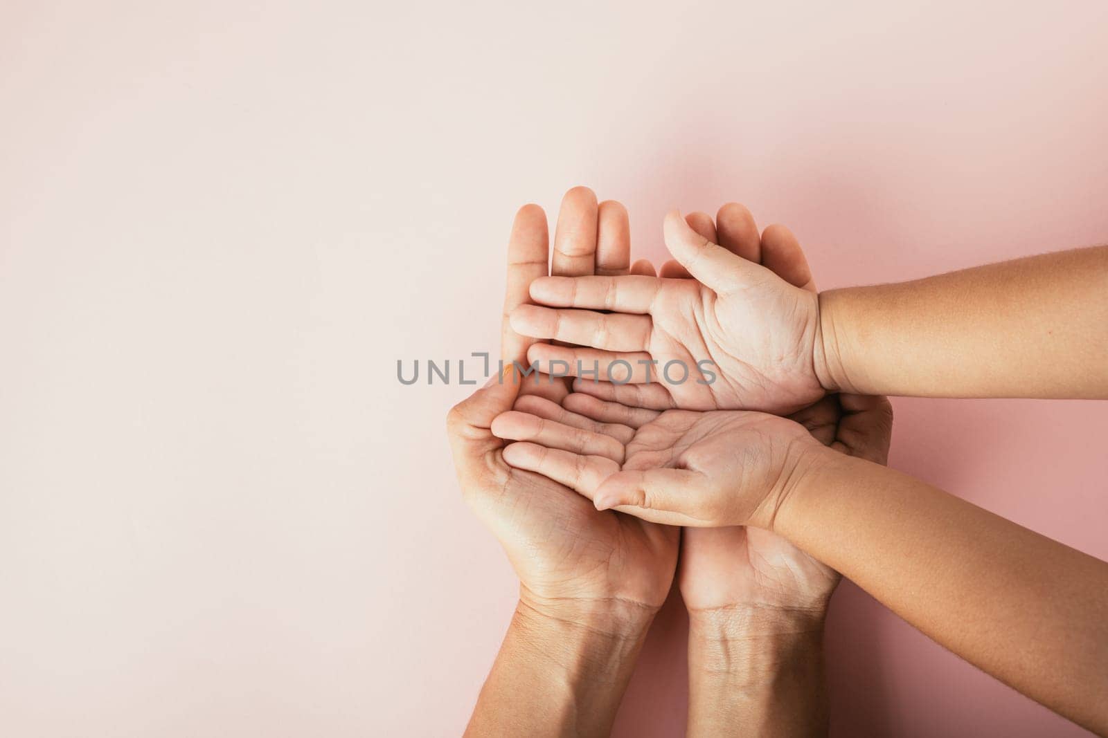 Top view of family hands stack isolated background. Parents and kid hold empty space symbolizing support and love on Family and Parents Day. by Sorapop