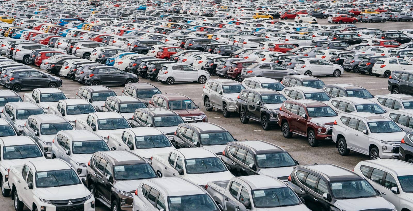 Lamchabang, Thailand - July 02, 2023 Rows of brand new sedans in a bustling factory warehouse showcase the modern technology and global reach of the automotive industry.