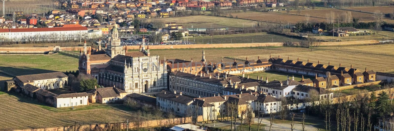 Aerial shot over Certosa di Pavia monastery with lawn fields by Robertobinetti70