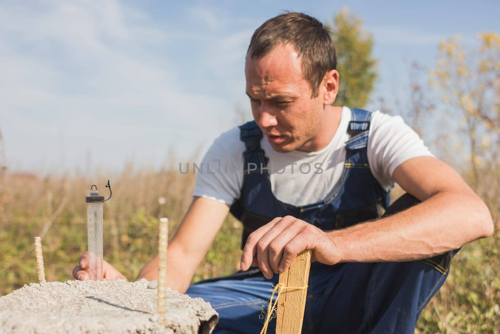 Worker builder in jumpsuit working outdoors, portrait, close up