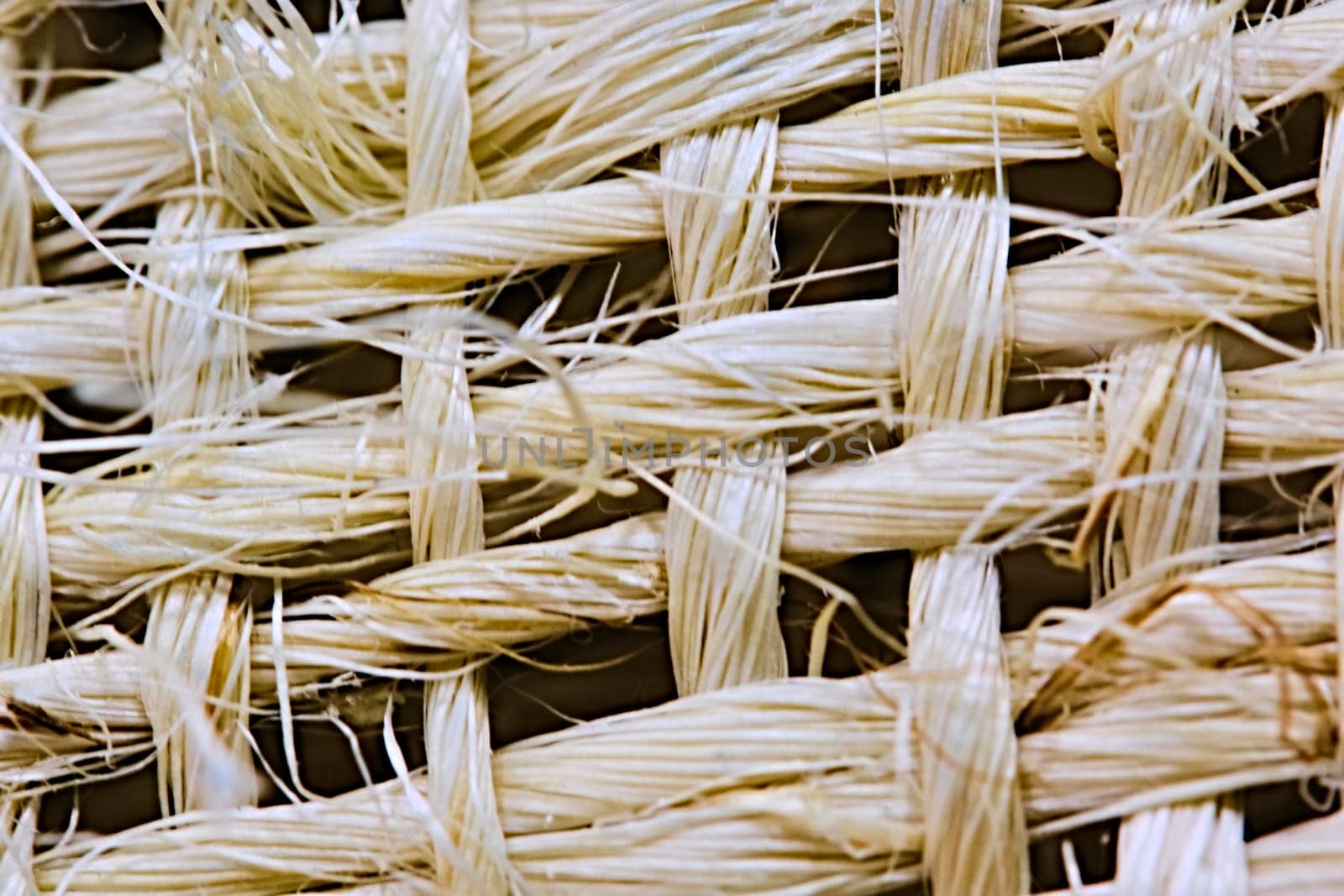 Texture of woven beige straw, background of braids from the plant stem close-up. macro by lempro