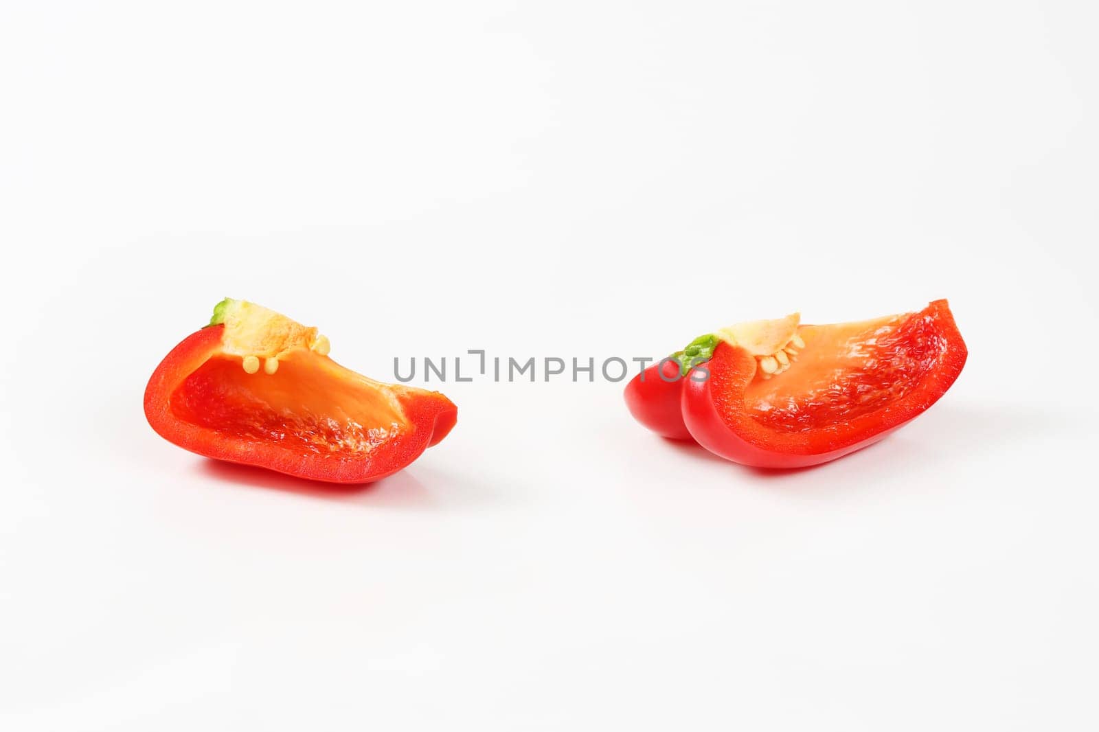 Two red bell pepper quarters by Digifoodstock