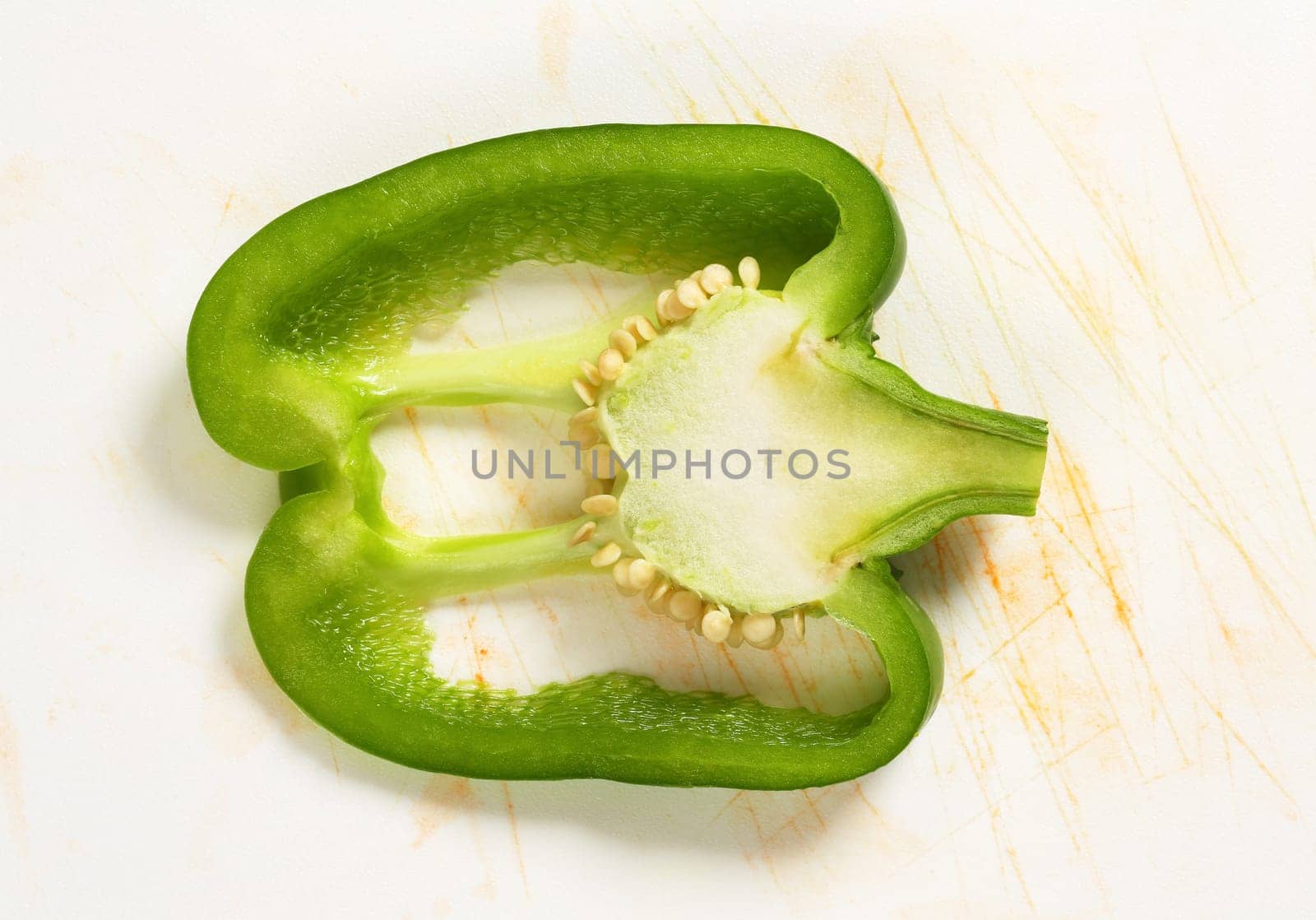 Slice of green bell pepper by Digifoodstock