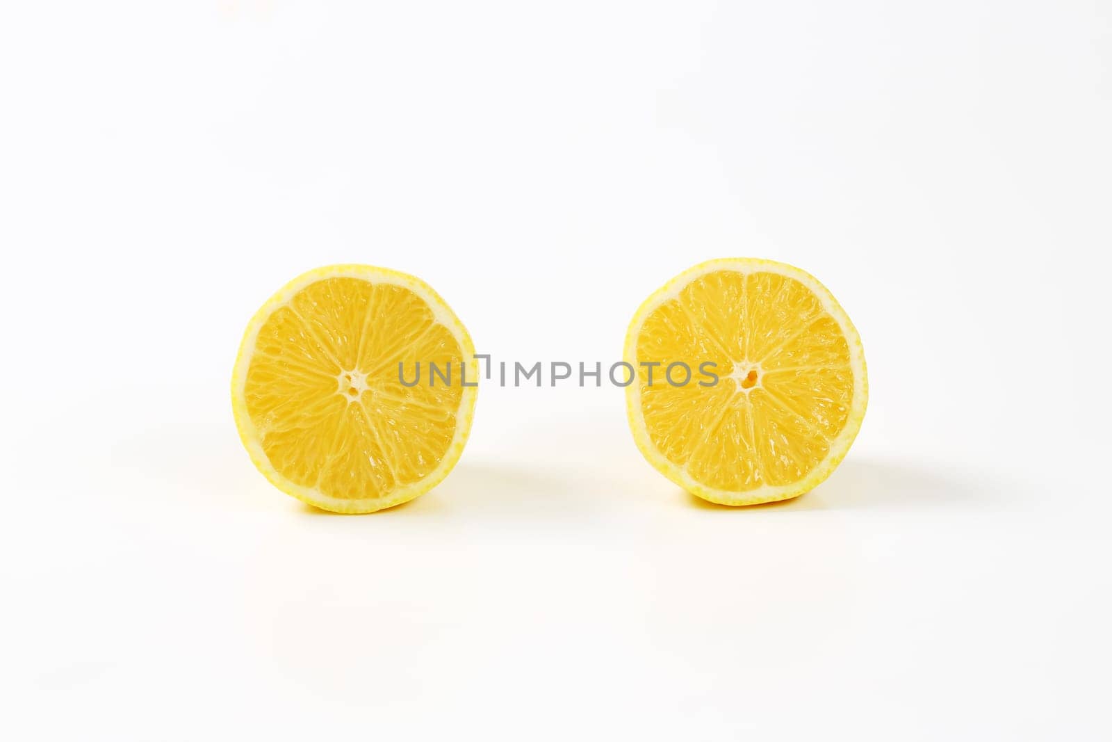 Two fresh lemon halves by Digifoodstock