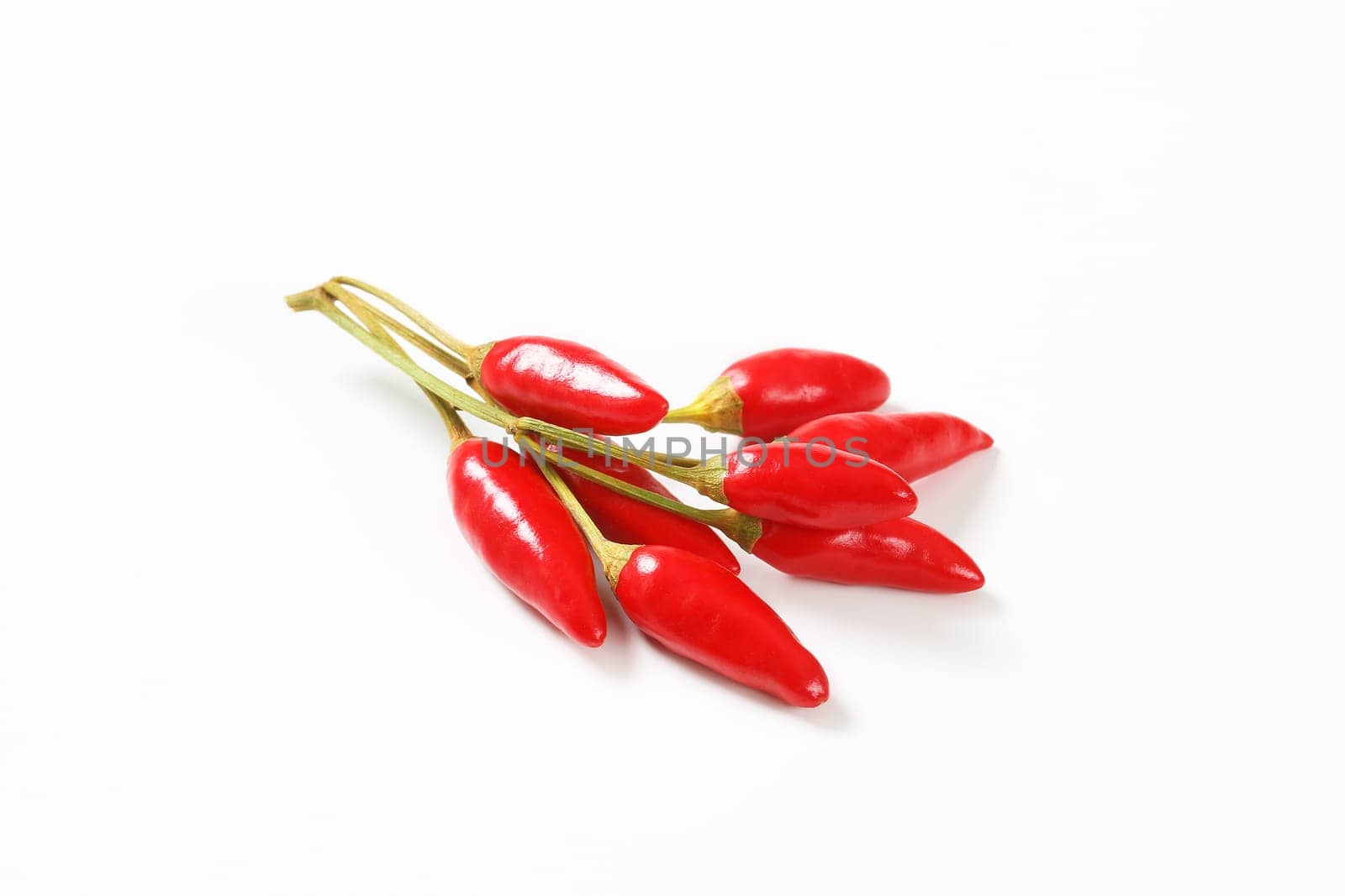 Small red chili peppers on white background