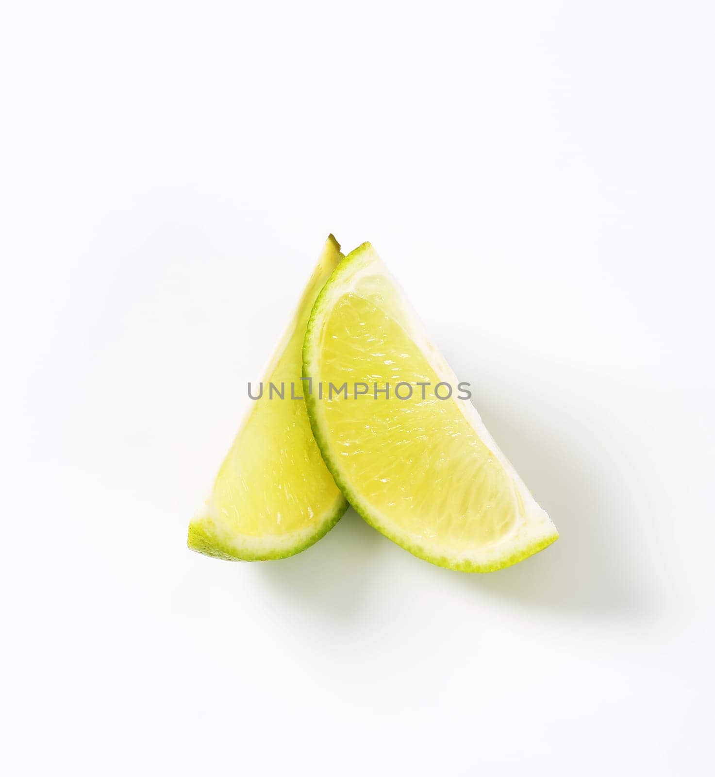 Two lime fruit wedges by Digifoodstock