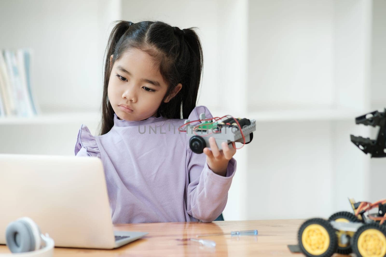 STEM education concept. Asian young girl learning robot design. by ijeab