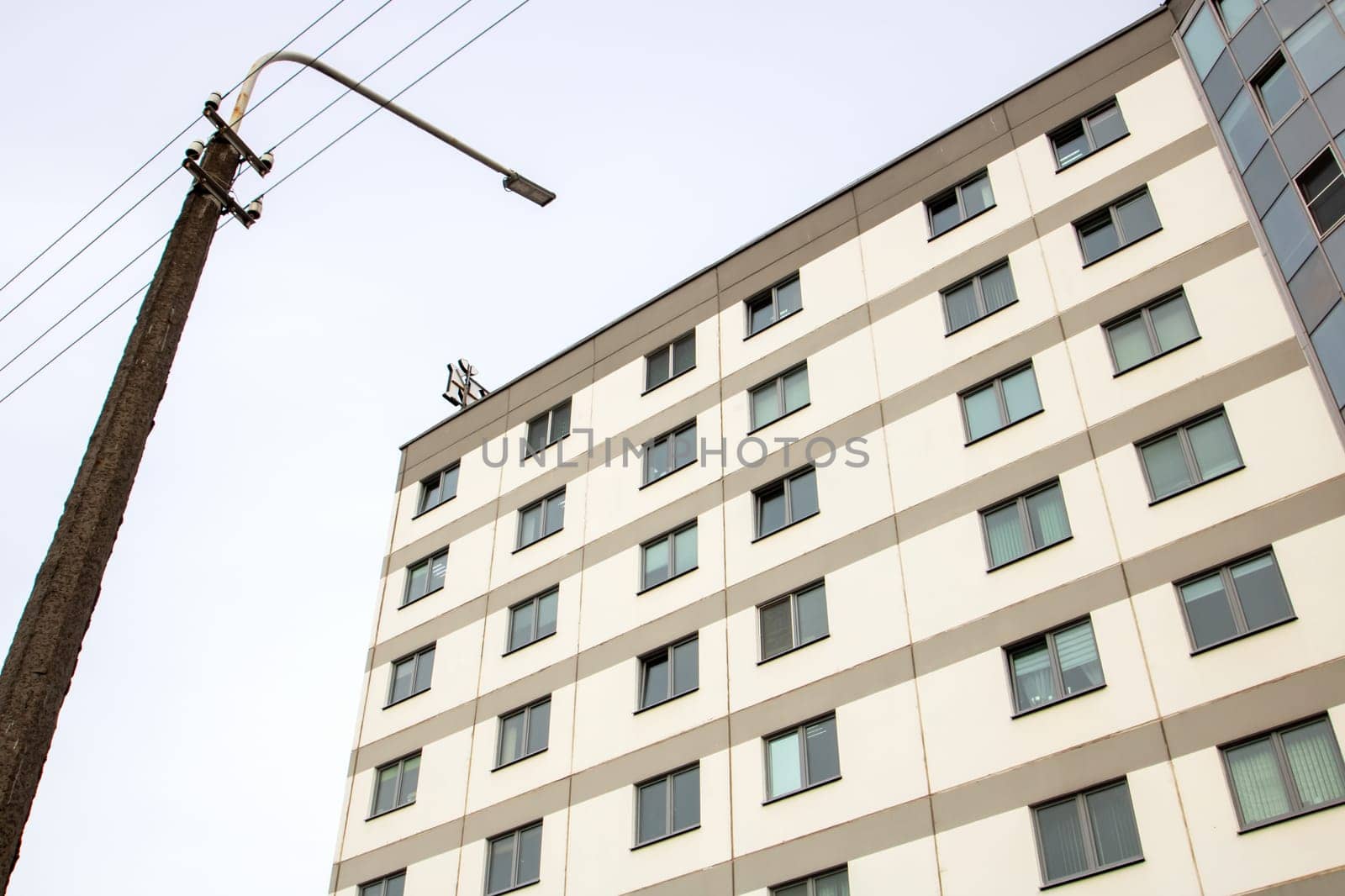 Windows of a multi-storey tall building against the background of the sky