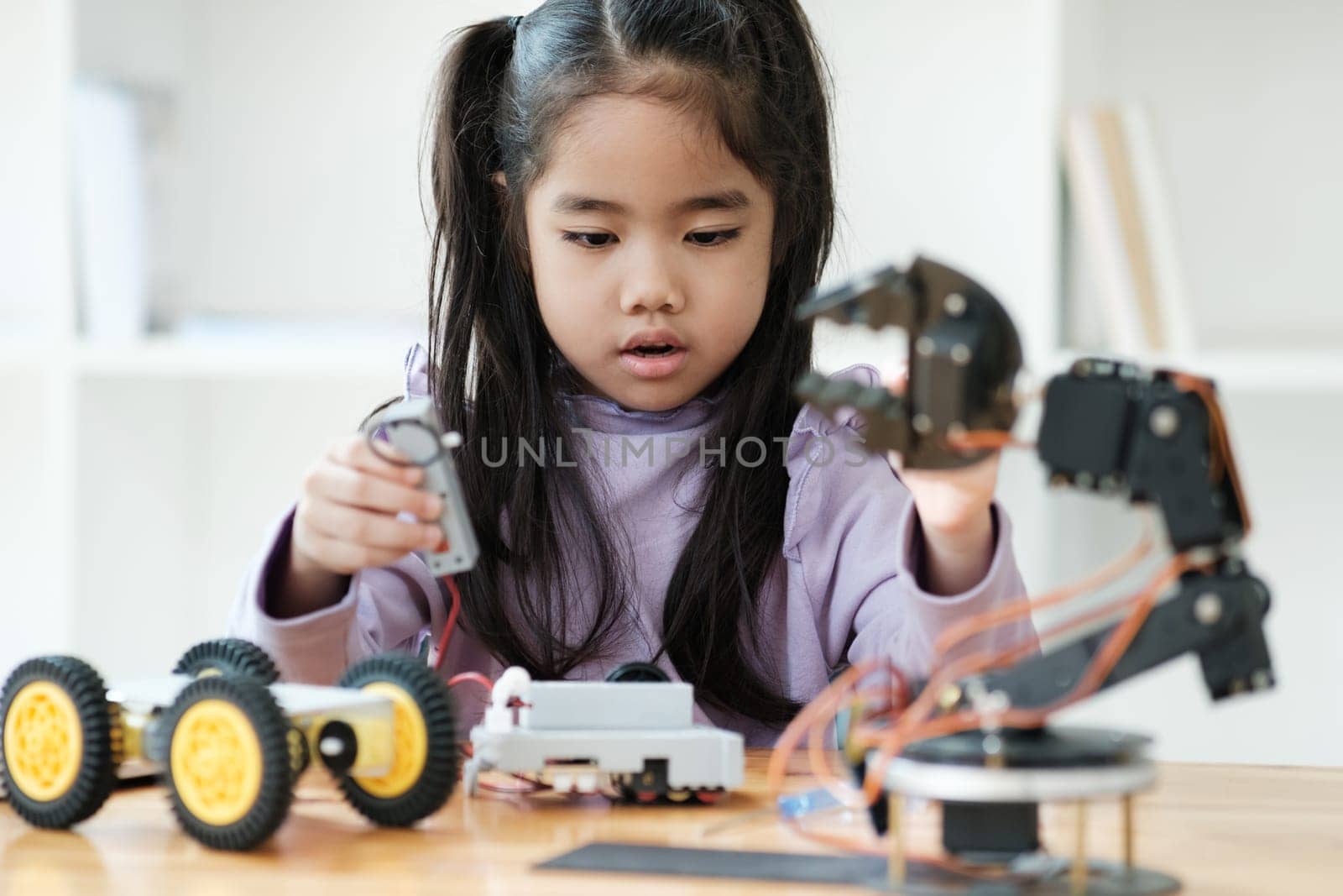 STEM education concept. Asian young girl learning robot design. by ijeab