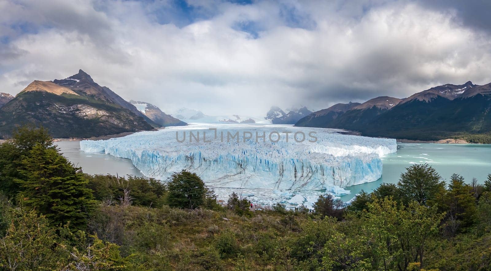 Stunning glacier view with mountains under cloudy sky. Perito Moreno