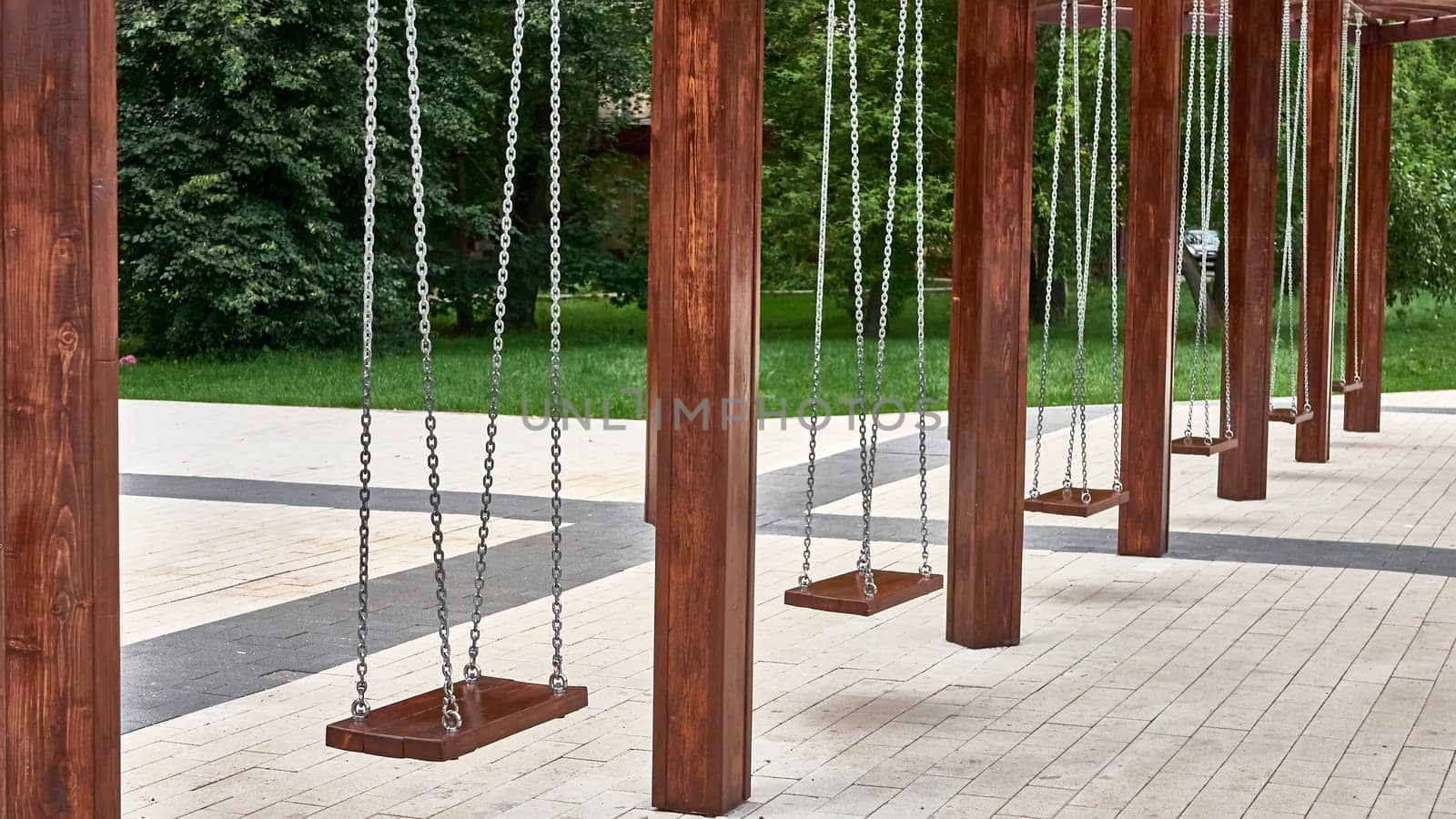 empty swings for children in the city park. master plan by lempro