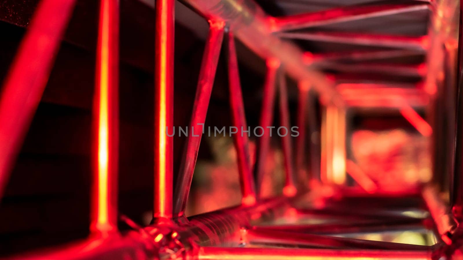 aluminum truss for lighting equipment illuminated with red light. color by lempro