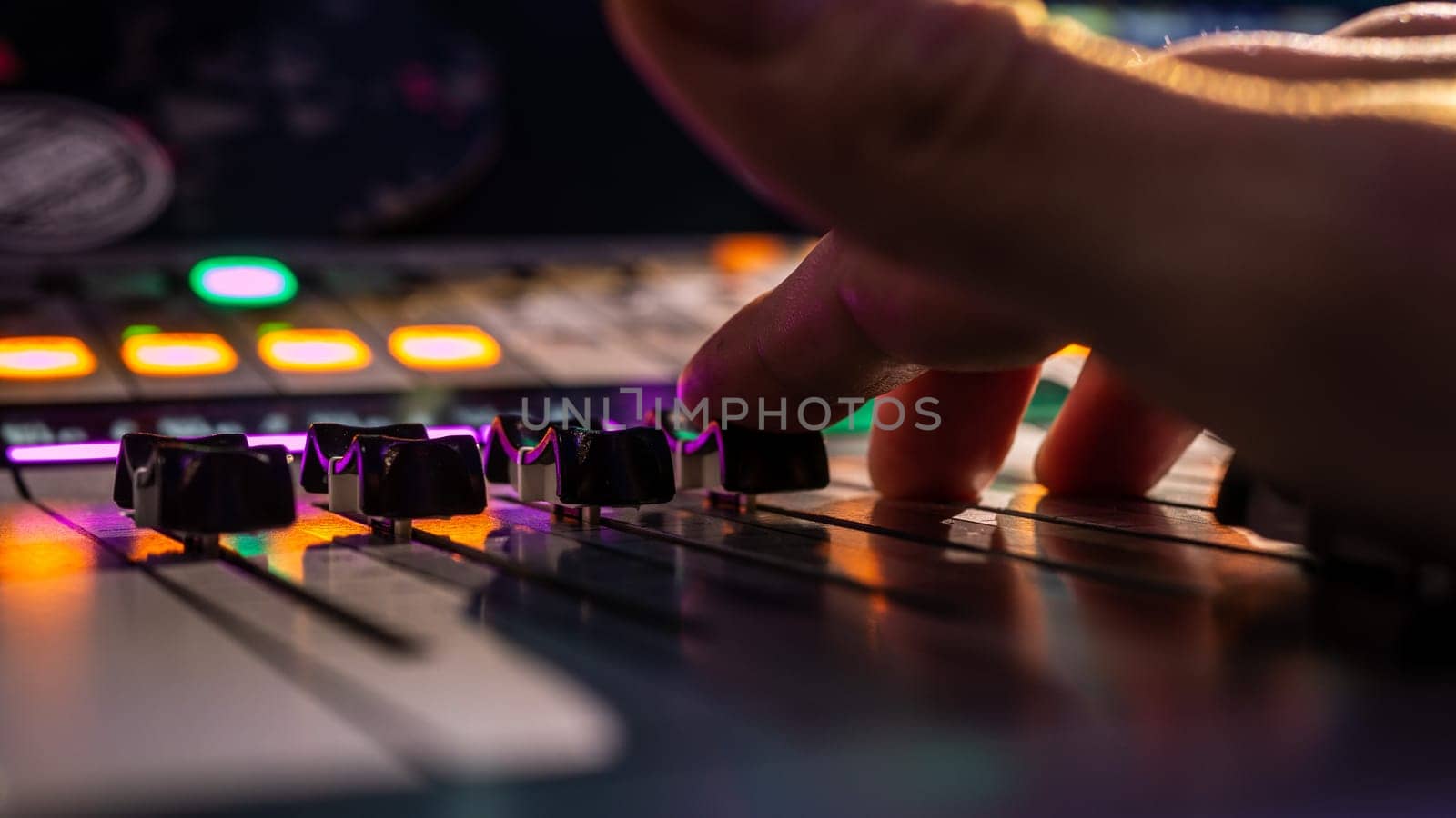 Sound engineer works with sound mixer, hands close-up
