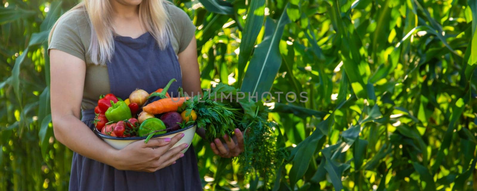 woman in the garden with vegetables in her hands.