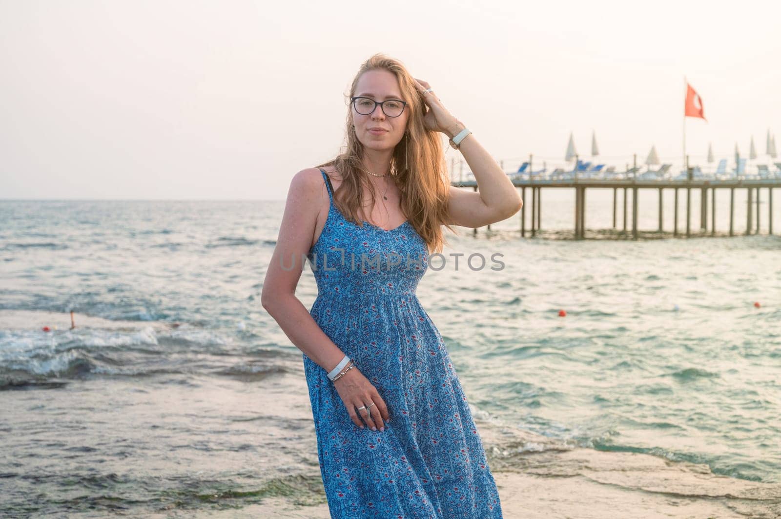 Woman sits on the beach and looks at the sea in Alanya city, Turkey. Travelling or vacation concept