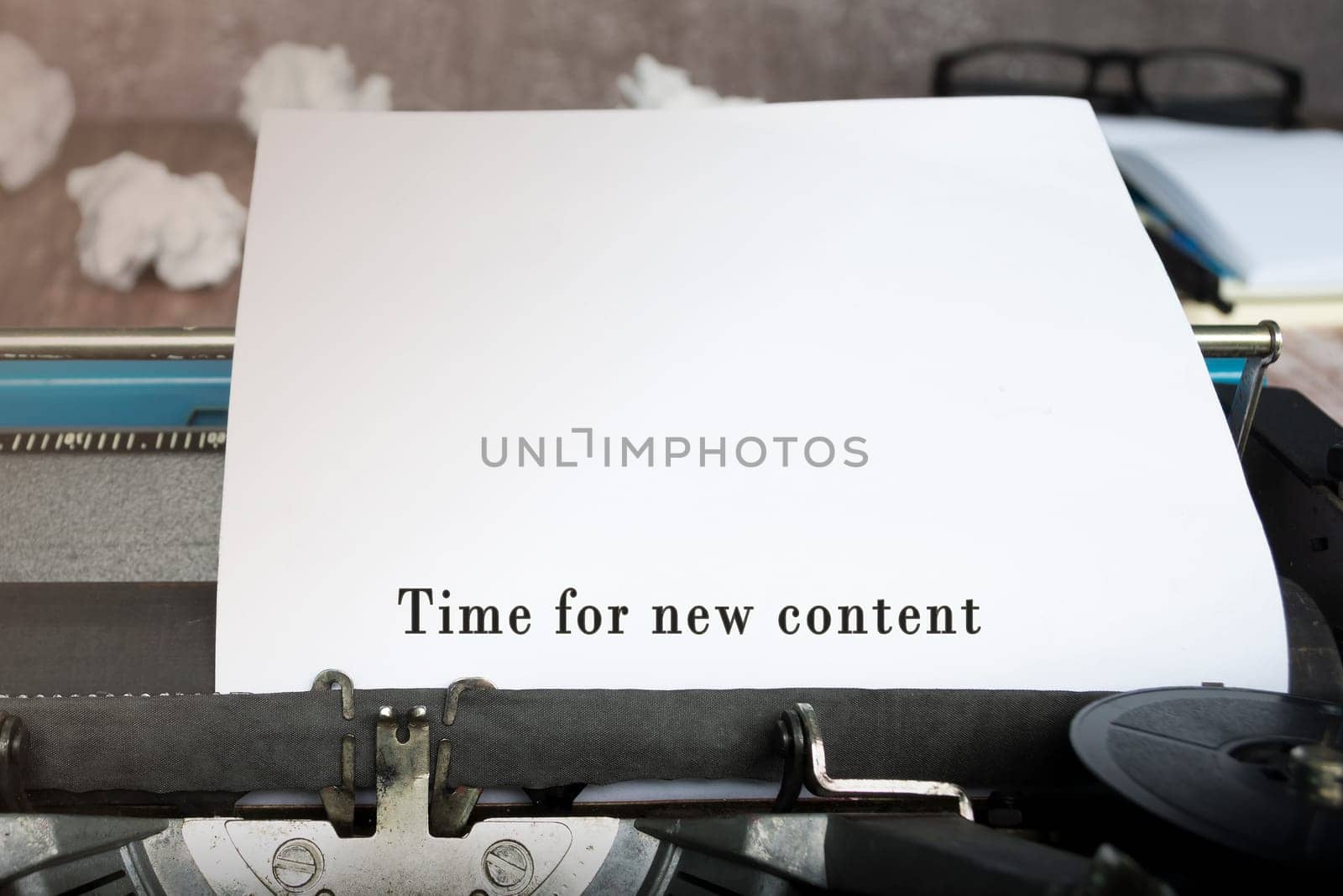 Time for new Content text on an old typewriter with trash paper background.