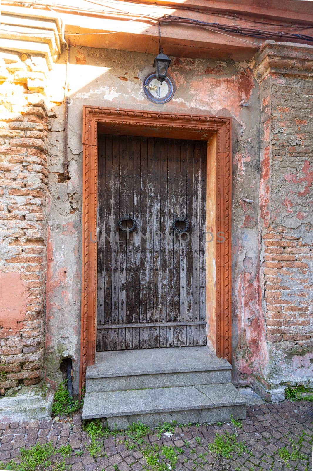 the wooden entrance doors of old rural houses in the Italian countryside