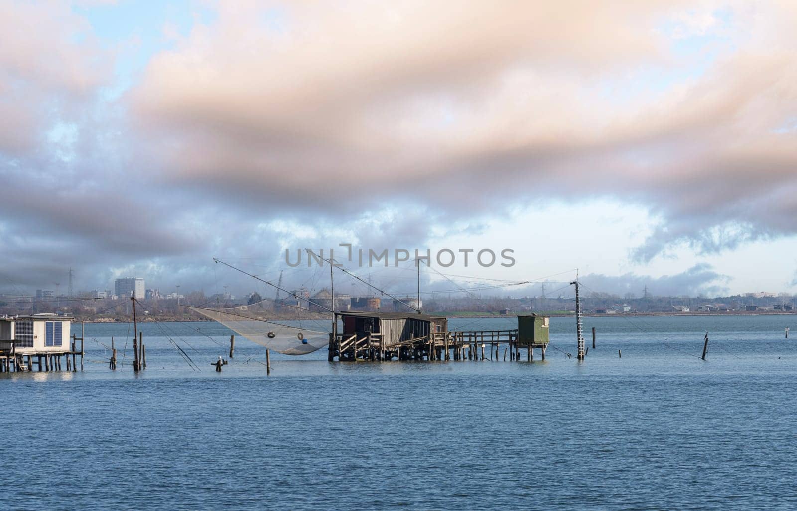 Comacchio, Italy. January 25, 2024. Panoramic view  of the wooden fishermen's shacks in the Comacchio valley