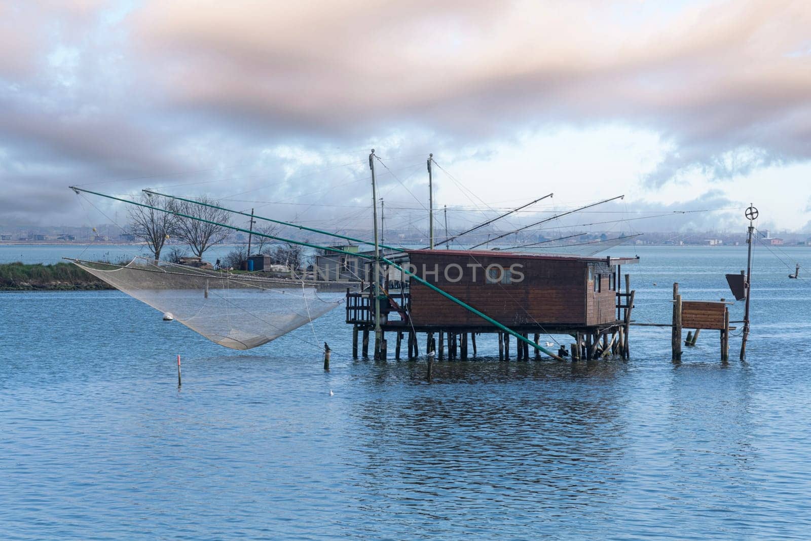 Comacchio, Italy. January 25, 2024. Panoramic view  of the wooden fishermen's shacks in the Comacchio valley