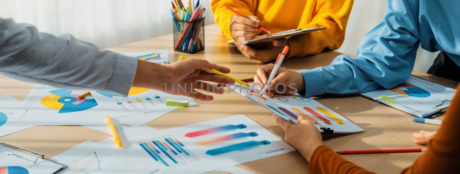 Startup company employee working together, analyzing BI dashboard paper on financial data report and planning strategic marketing for business success in panorama banner. Synergic