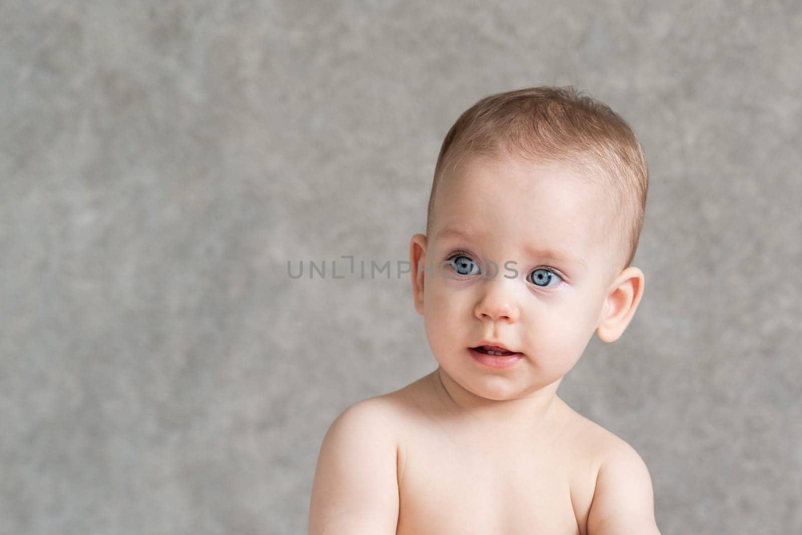 Shirtless kid with surprise on his face.