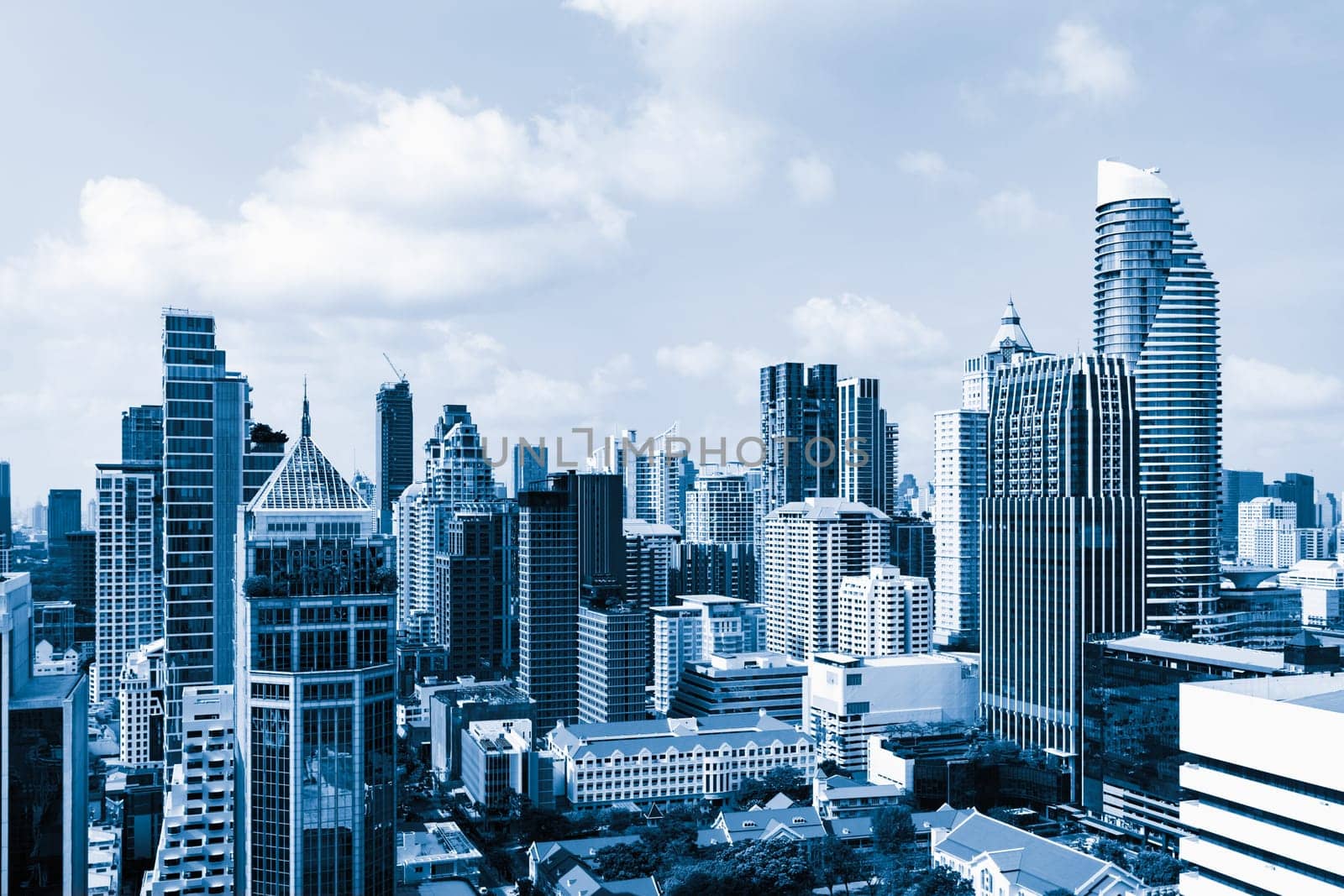 Closeup image of Bangkok cityscape. Modern skyscrapers with monochrome blue filter. Modern architectural building skyline with blue sky. Side view. Business background. Day light. Ornamented.
