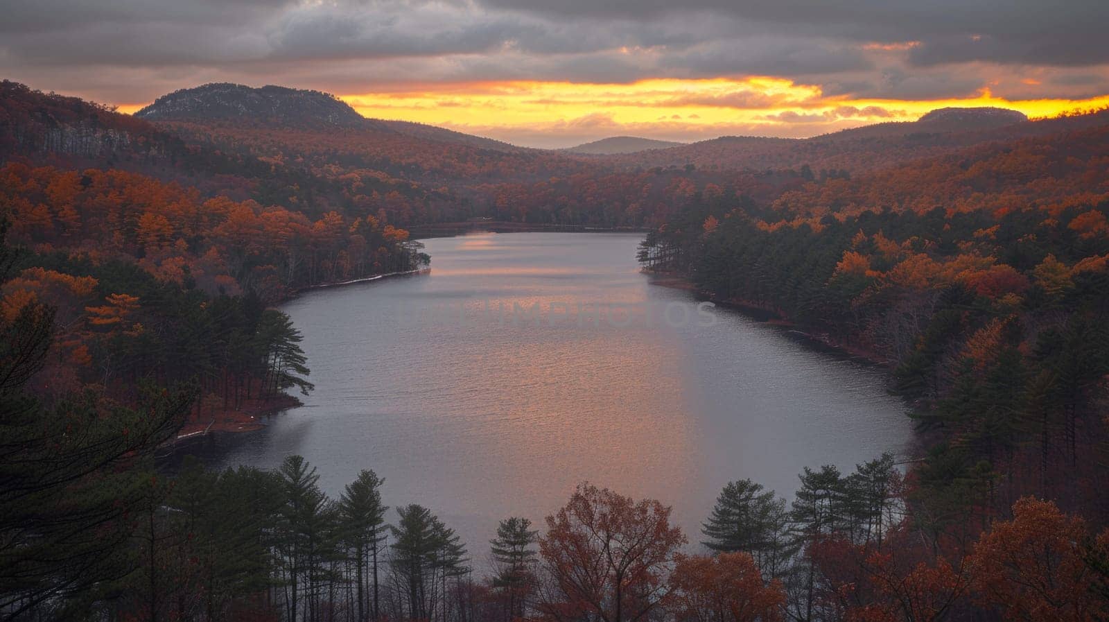 A view of a lake surrounded by trees and mountains