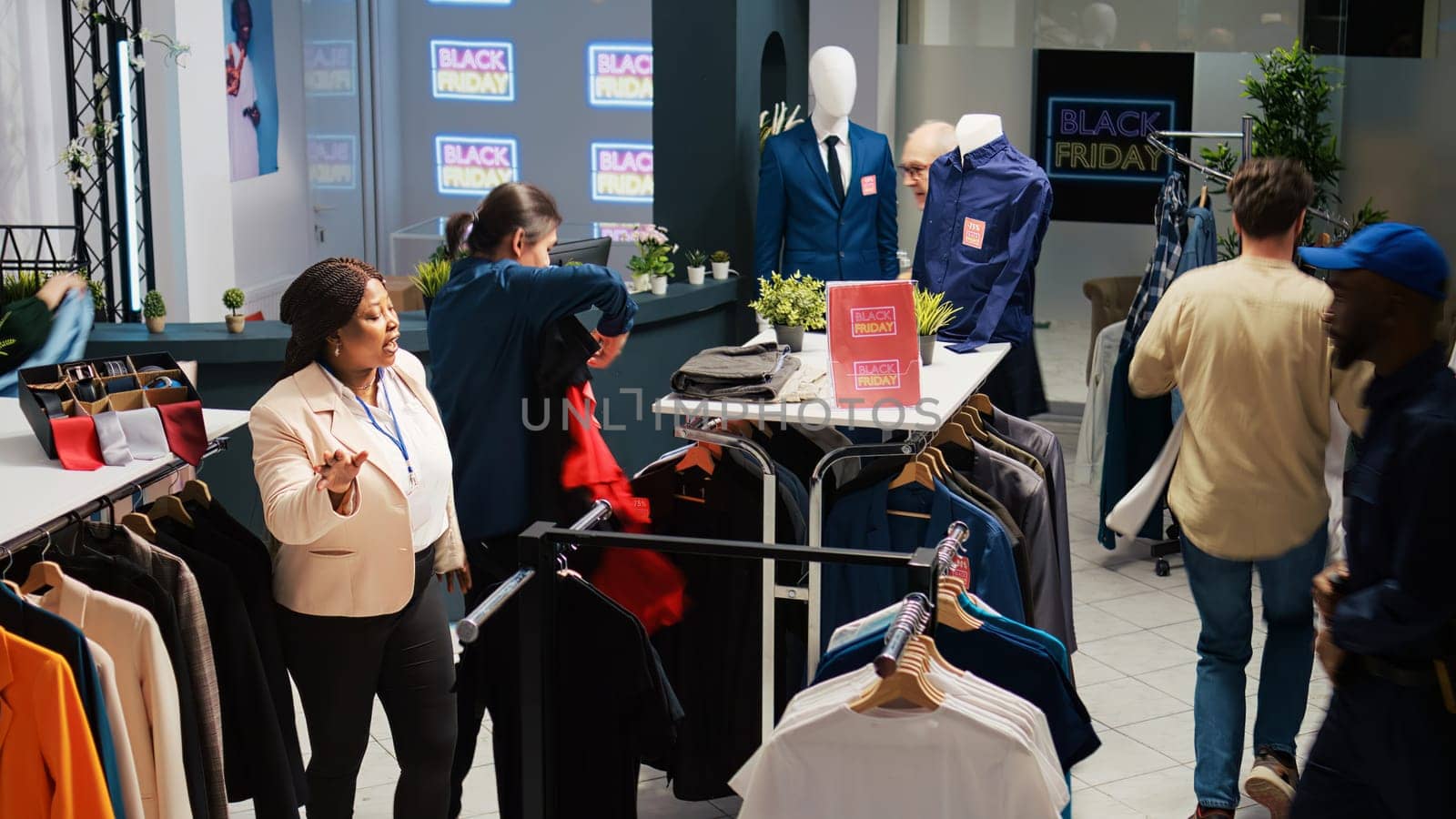 Stressed people on black friday rushing to buy clothes at half price, fashion retail store with red price tags. Group of customers hunting for bargains during seasonal sales in shopping center.