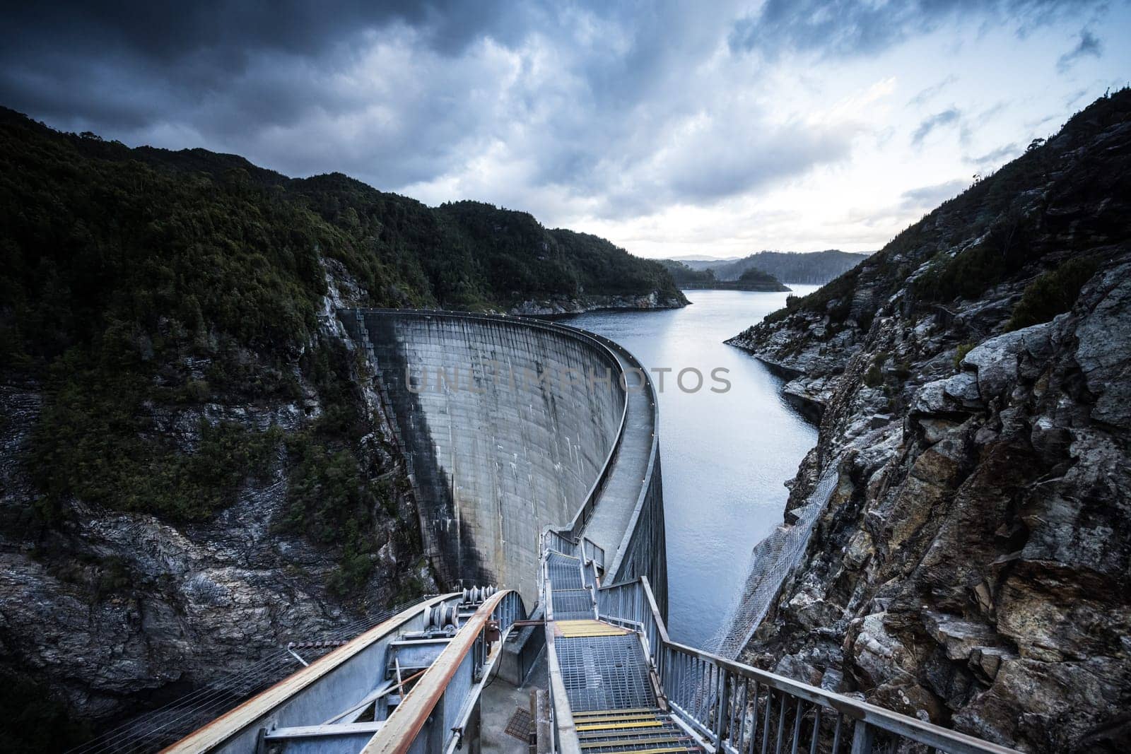 View of the Gordon Dam on a cool summer's day. It is a unique double curvature concrete arch dam with a spillway across the Gordon River near Strathgordon, South West Tasmania, Australia