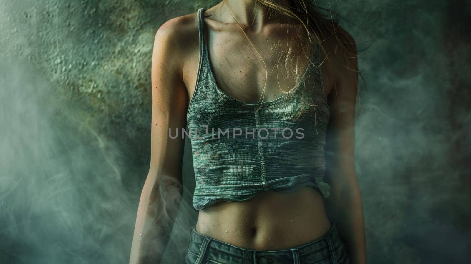 A woman in a tank top standing next to some smoke