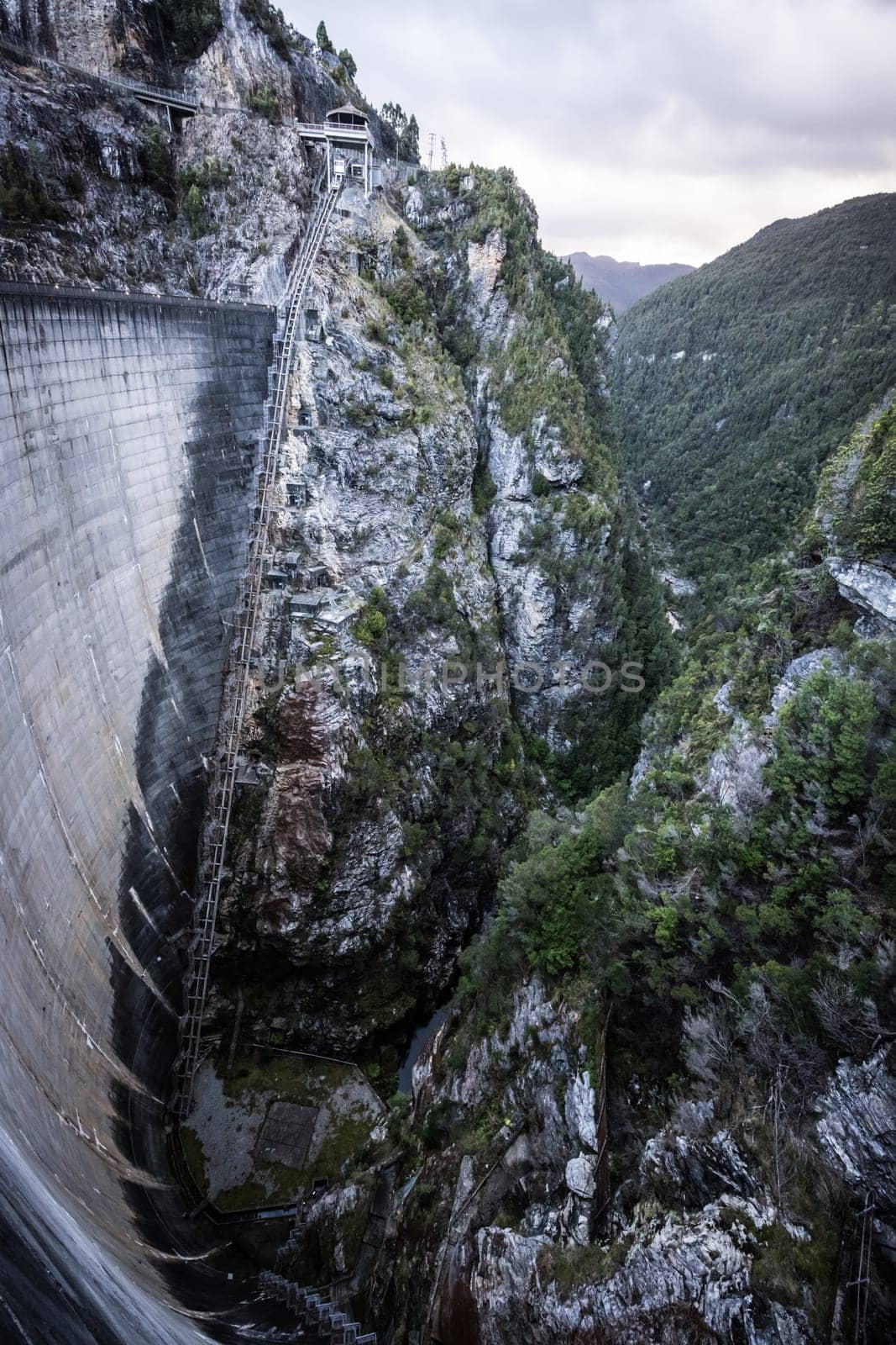 View of the Gordon Dam on a cool summer's day. It is a unique double curvature concrete arch dam with a spillway across the Gordon River near Strathgordon, South West Tasmania, Australia