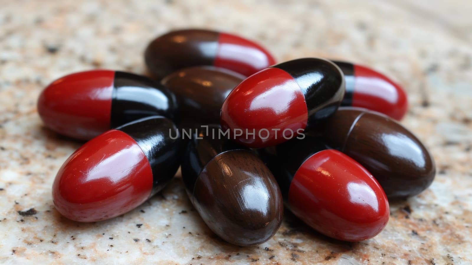 A bunch of pills are on a table with red and black caps