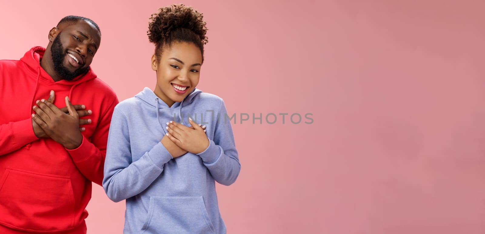 Couple receive compliments look good together. Portrait charming friendly loving african-american girlfriend boyfriend press palms heart touched pleased smiling broadly grateful moving words by Benzoix