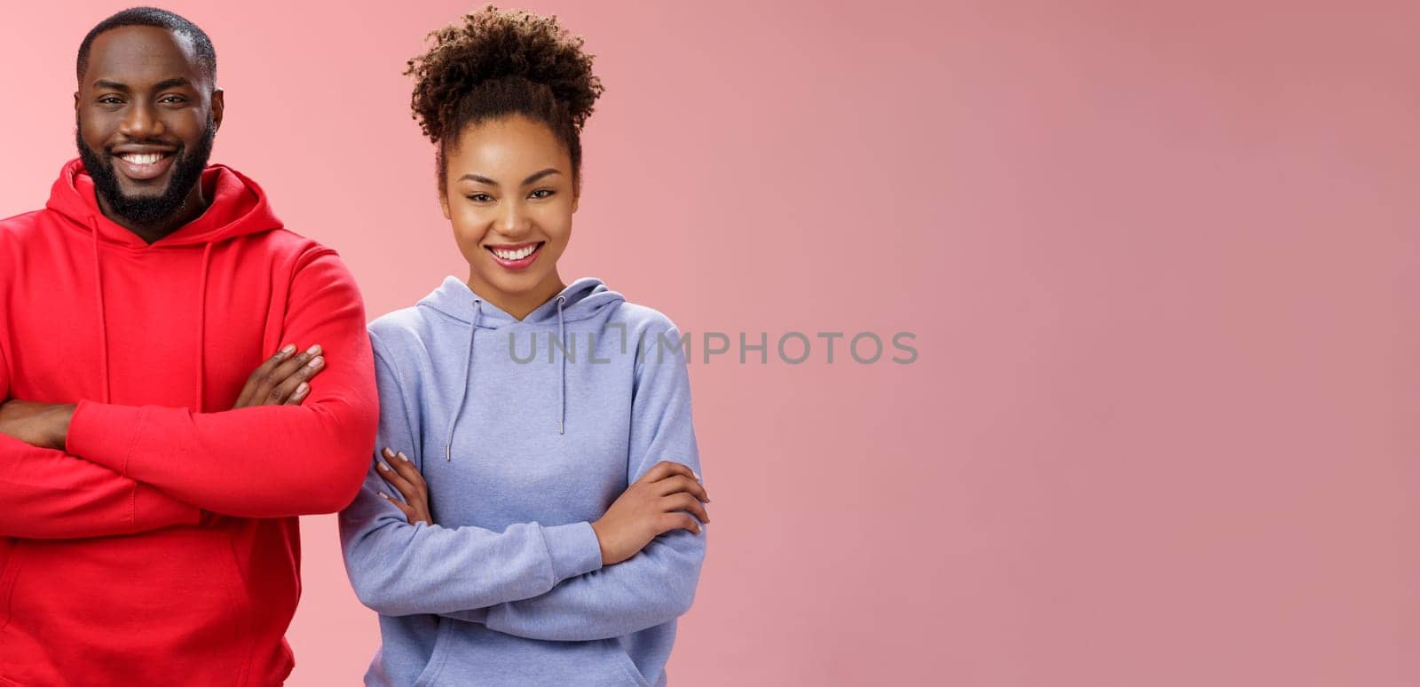 Charming happy professional team two african american man girl smiling broadly self-assured own abilities cross arms chest grinning friendly unbeatable working together, standing pink background by Benzoix