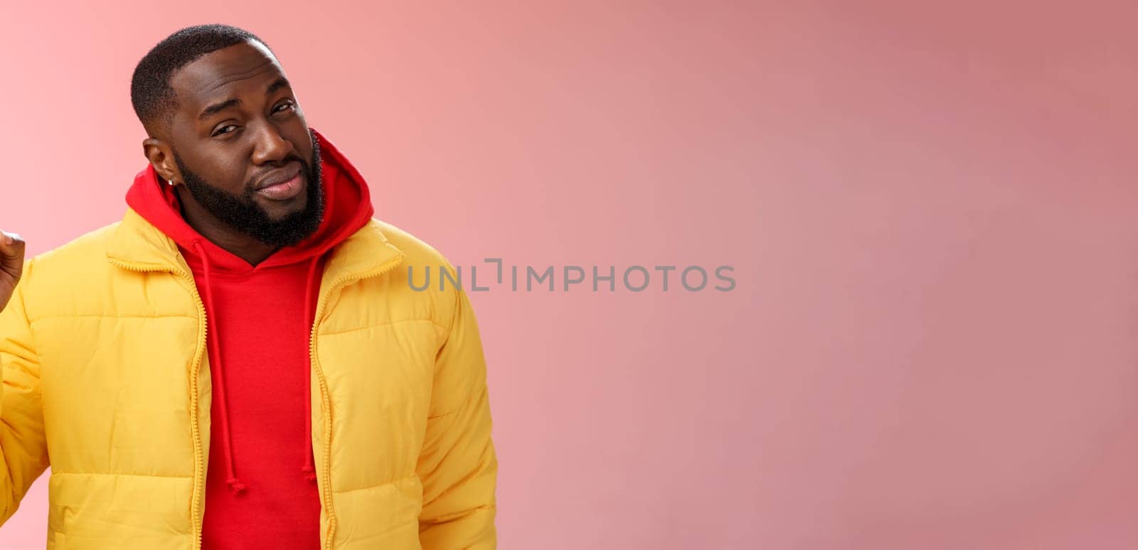 Doubtful displeased african american bearded male customer pointing up index finger squinting cringing disbelief hesitant uncertain product quality, standing questioned frustrated pink background by Benzoix