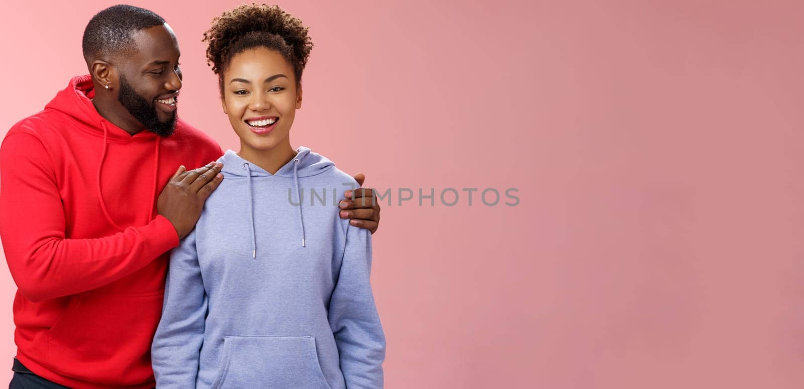 Supportive boyfriend congratulating girlfriend win first prize feel proud touching girl shoulder saying encouraging pleasant words smiling look caring lovely grinning, standing pink background by Benzoix
