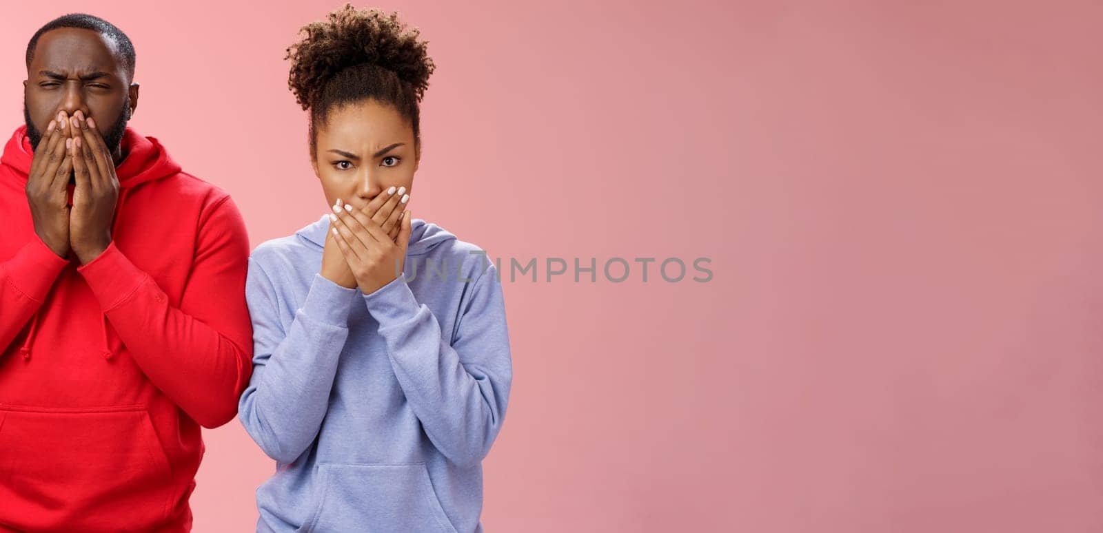 Romantic couple african american boyfriend girlfriend feel sick after eating dinner restaurant press palms mouth frowning wanna puke vomit, standing disgusted shocked pink background.