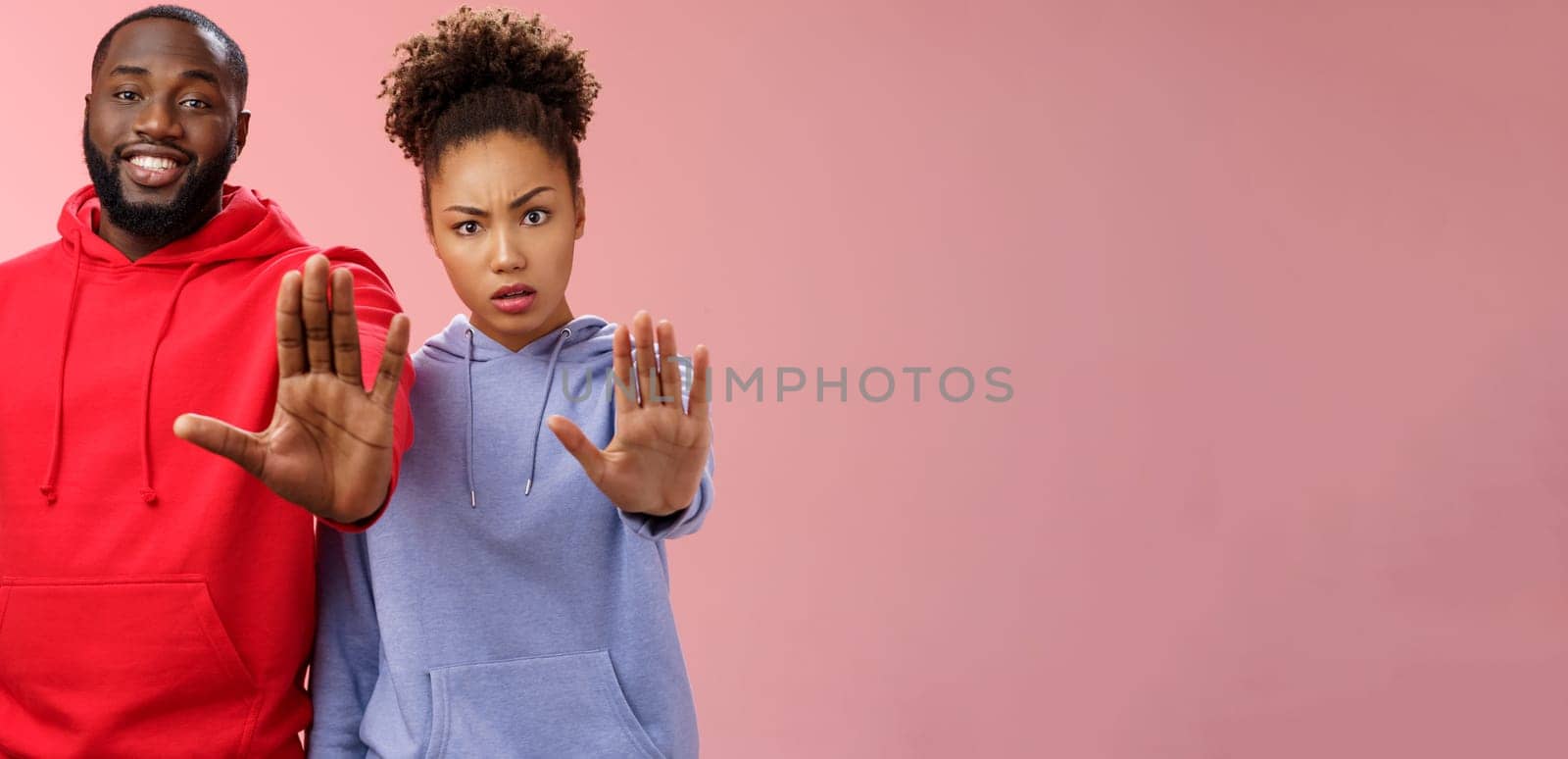 Friend asking stop worrying health raise palm forbidden enough dangerous gesture. Two african american man woman show hand prohibition taboo gesture persuading quit smoking, pink background by Benzoix