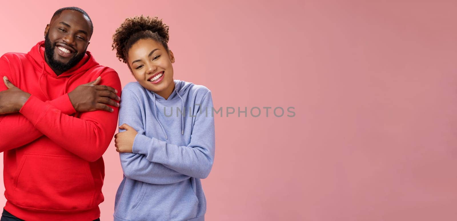 Two african american man woman couple feel comfortable warm together embracing each other cuddling happily tilting head look cute express love strong healthy relationship, smiling delighted.