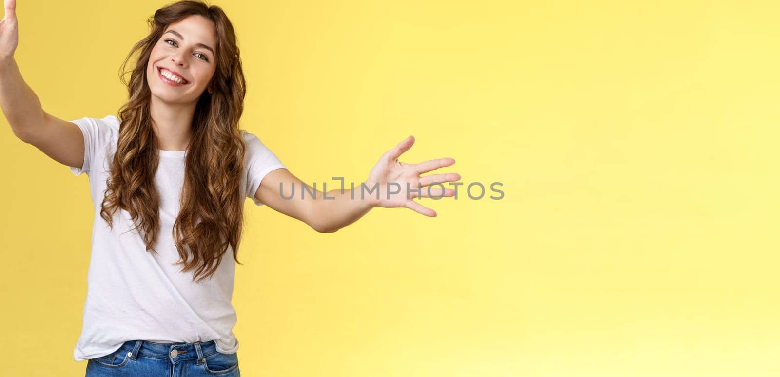 Wanna hold you tight. Romantic sincere gentle cute caucasian girl long beautiful curly hair tilt head lovely extend arms give cuddles wanna hug friend embracing dear guests yellow background by Benzoix